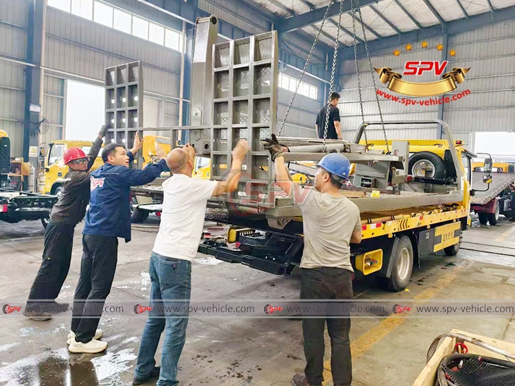 Wrecker Truck Body Loaded onto Flatbed Truck in SPV Factory